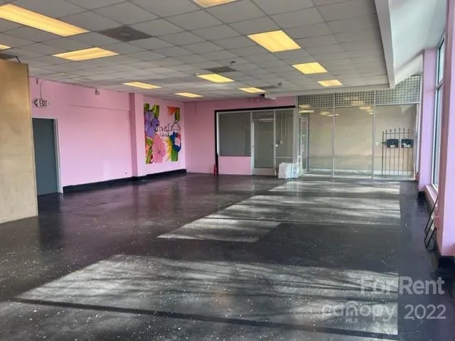 a view of water heater room with wooden floor