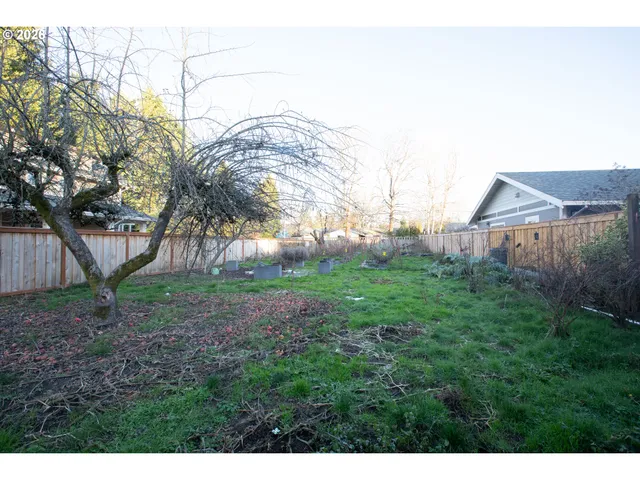a backyard of a house with table and chairs