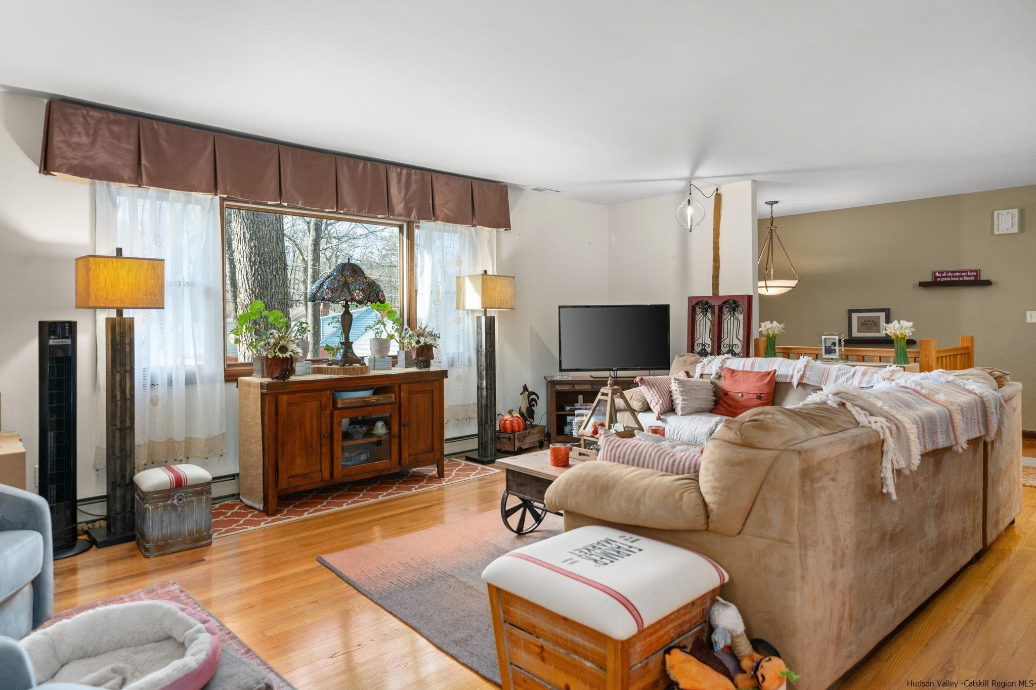 154 Mountain View Road Tillson, NY 12486 - Photo 3 of 25 a living room with furniture a flat screen tv and a large window