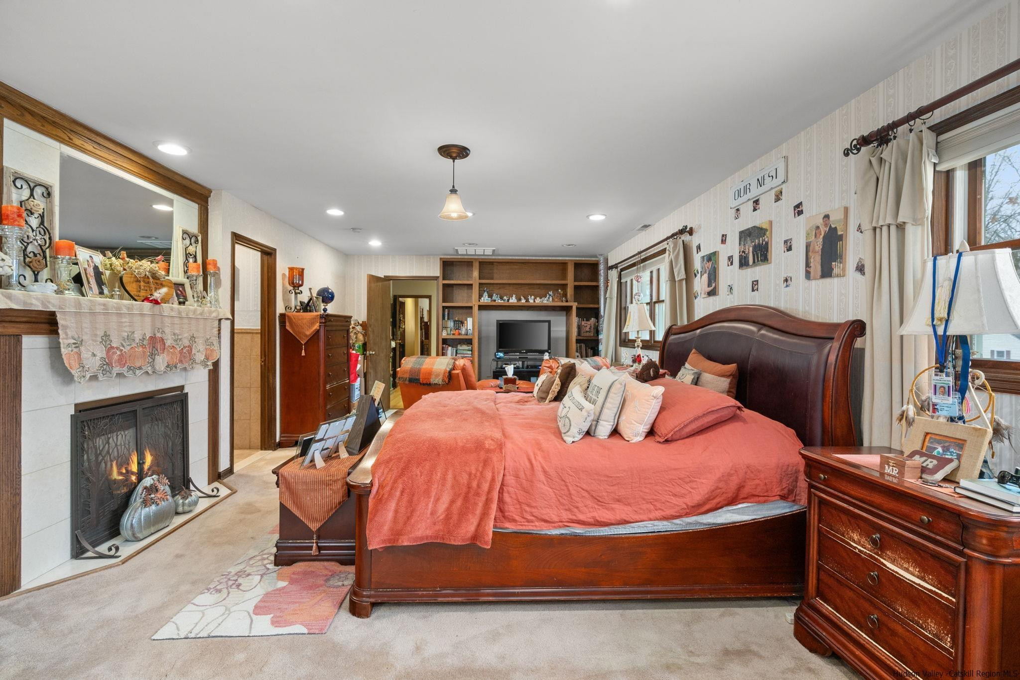 154 Mountain View Road Tillson, NY 12486 - Photo 10 of 25 a bed room with a bed and a fireplace