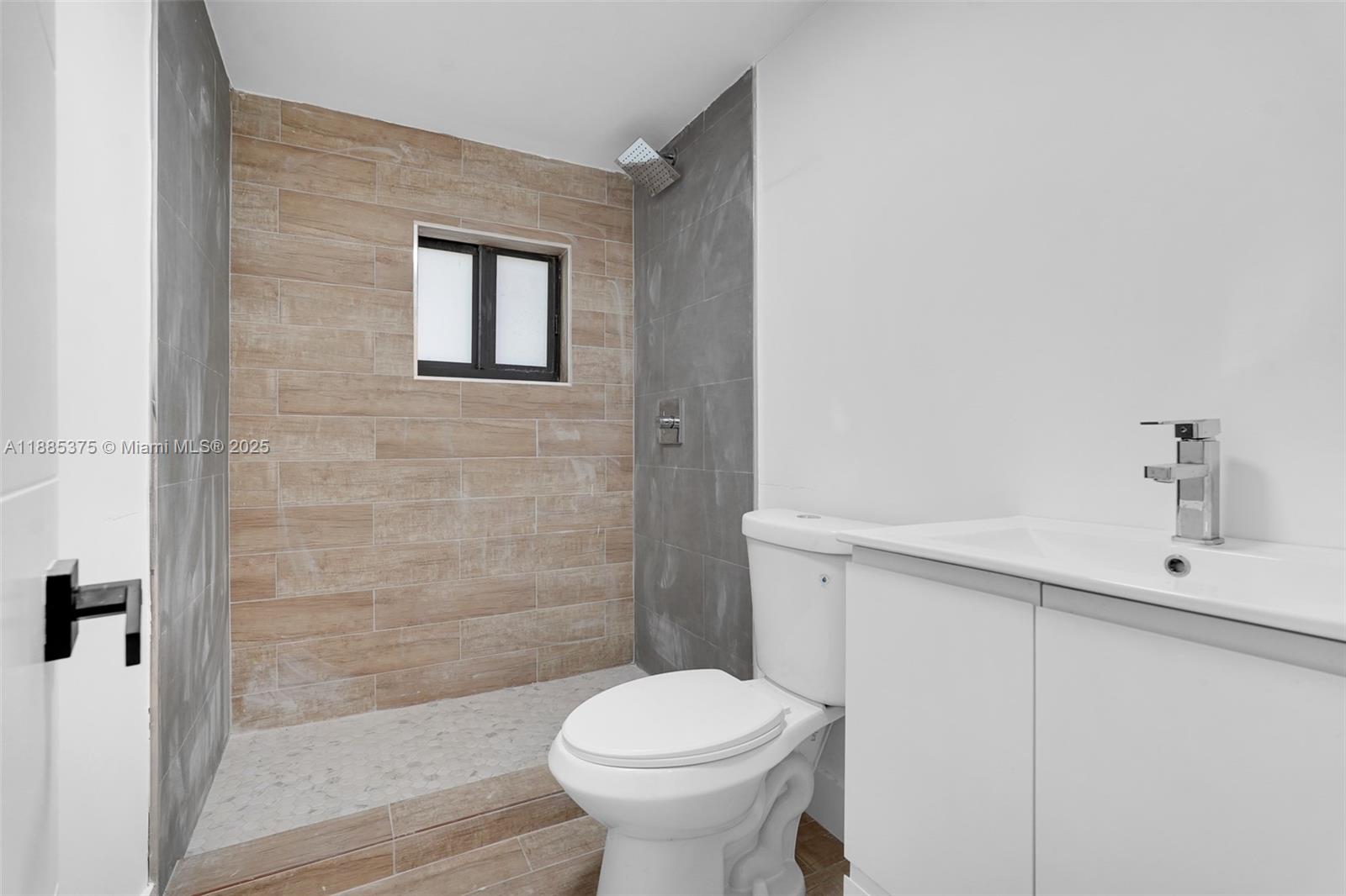 1814 Northwest 2nd Court, Unit 4 Miami, FL 33136 - Photo 12 of 13 a bathroom with a toilet sink and shower