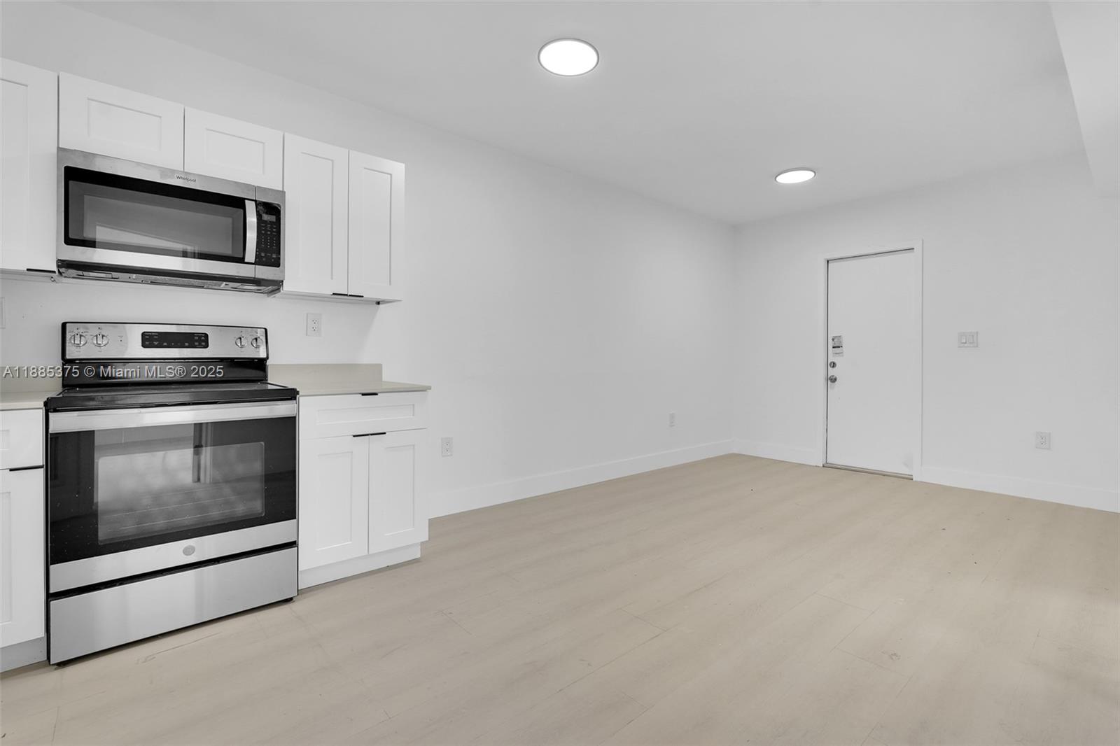1814 Northwest 2nd Court, Unit 4 Miami, FL 33136 - Photo 6 of 13 a kitchen with a stove and a microwave