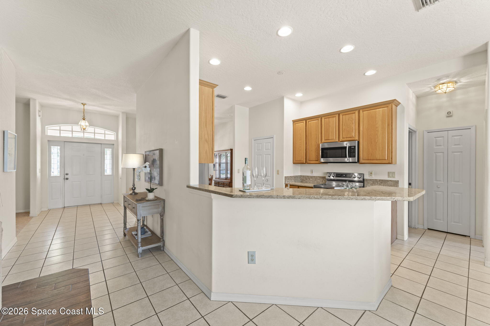 1123 Spring Oak Drive Melbourne, FL 32901 - Photo 21 of 67 a kitchen with stainless steel appliances a refrigerator and microwave
