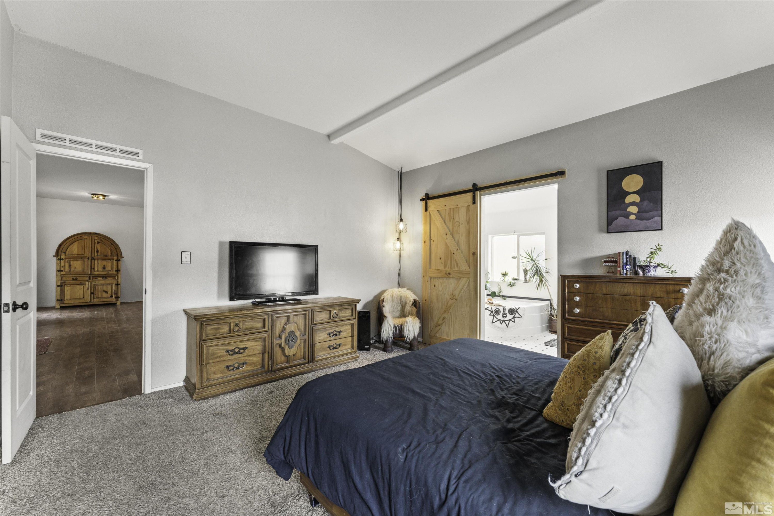 5158 Denali Way Reno, NV 89506 - Photo 9 of 24 a bedroom with a bed and a flat screen tv