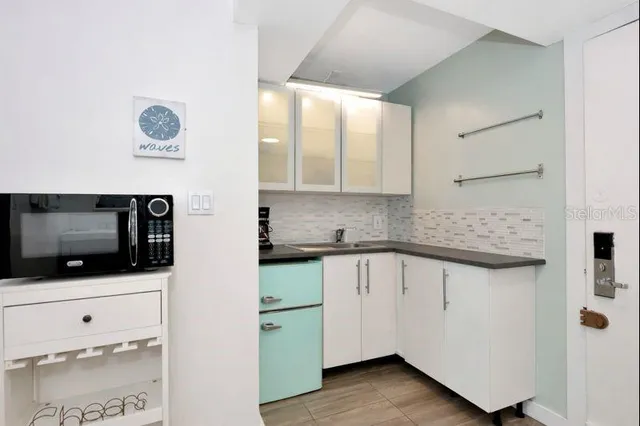 a kitchen with stainless steel appliances granite countertop a sink a stove and a microwave