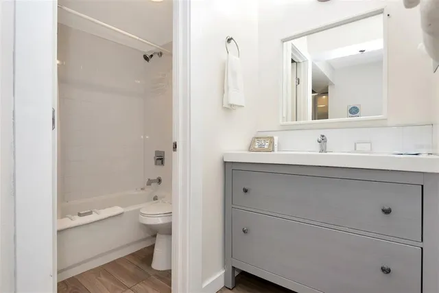 a bedroom with bed and wooden floor