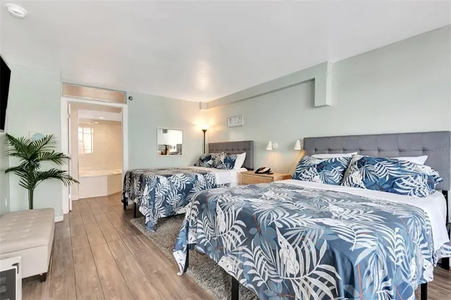 a bedroom with a bed and a flat screen tv