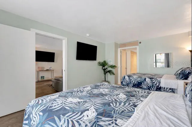 a bedroom with a bed and a potted plant