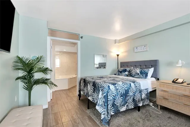 a bed room with bed and a flat screen tv