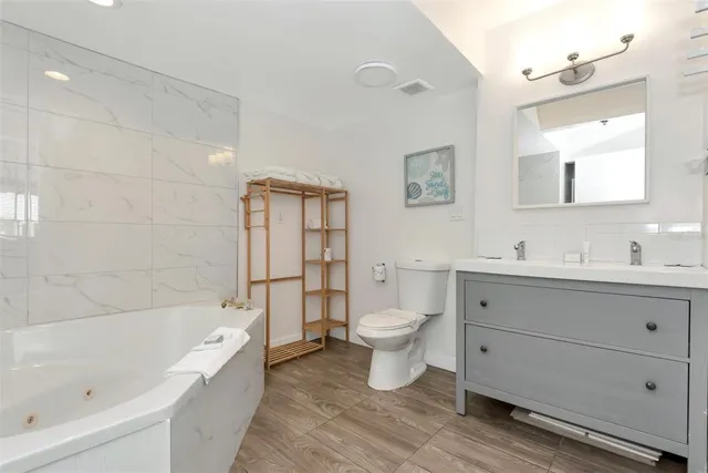 a bathroom with a toilet sink and mirror