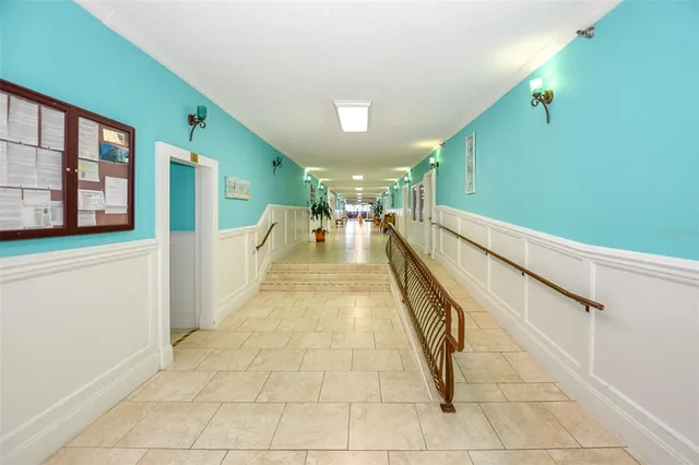 a hallway with a bench and painted walls