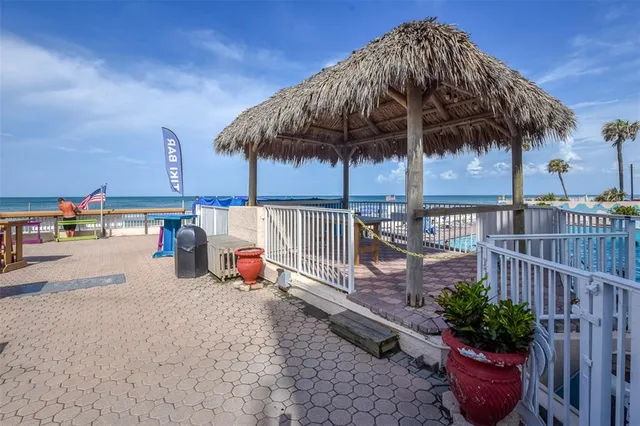 a view of a swimming pool with lawn chairs