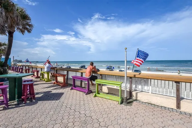 a street view with tall buildings and a yard