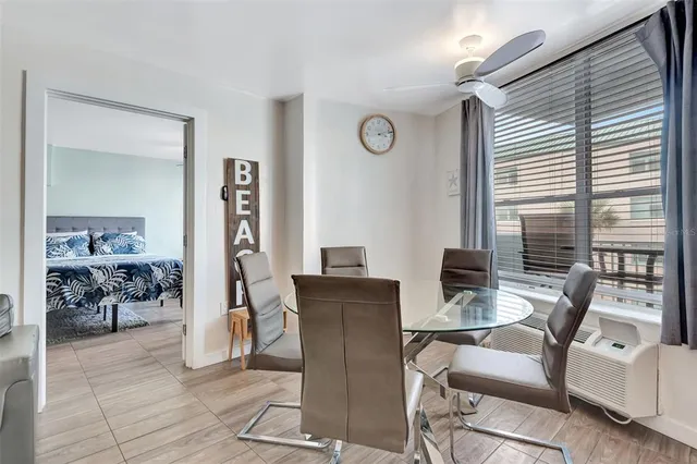 a view of a livingroom with furniture and a large window
