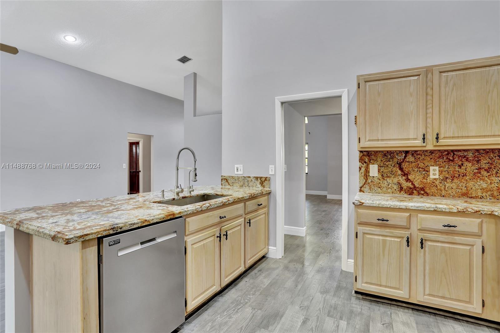 9641 Ridgeside Court Davie, FL 33328 - Photo 11 of 47 a kitchen with white cabinets appliances and sink