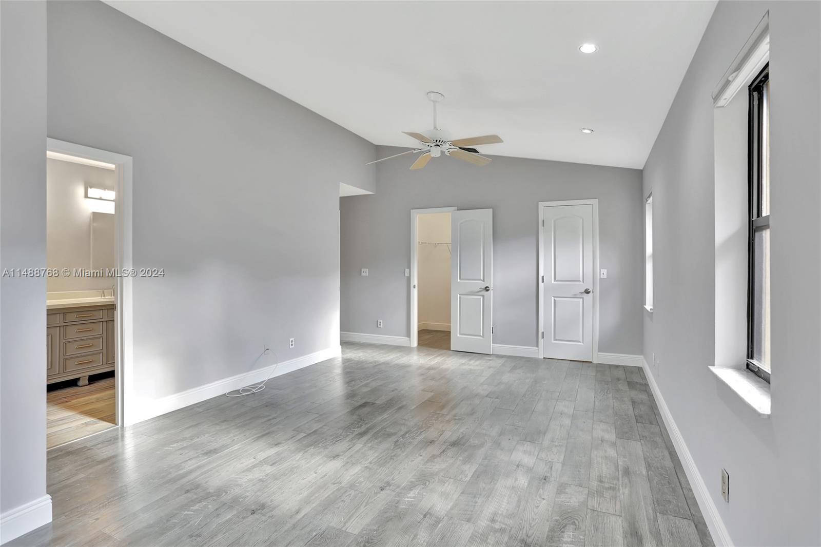 9641 Ridgeside Court Davie, FL 33328 - Photo 14 of 47 wooden floor in an empty room with a window