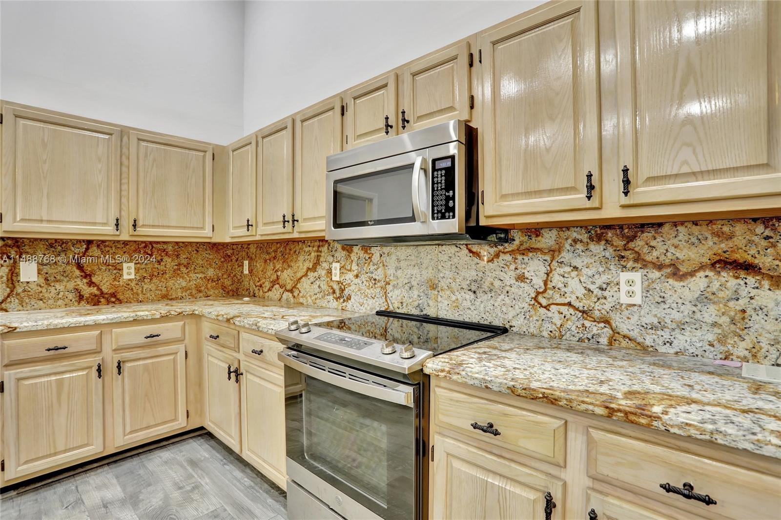 9641 Ridgeside Court Davie, FL 33328 - Photo 19 of 47 a kitchen with granite countertop a sink and cabinets