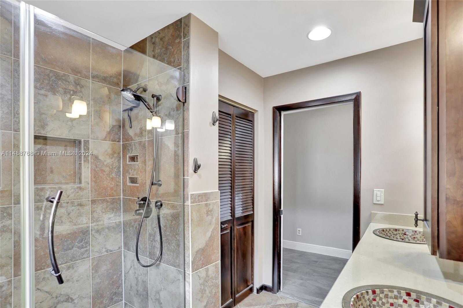 9641 Ridgeside Court Davie, FL 33328 - Photo 30 of 47 a bathroom with a glass shower door and a bathroom