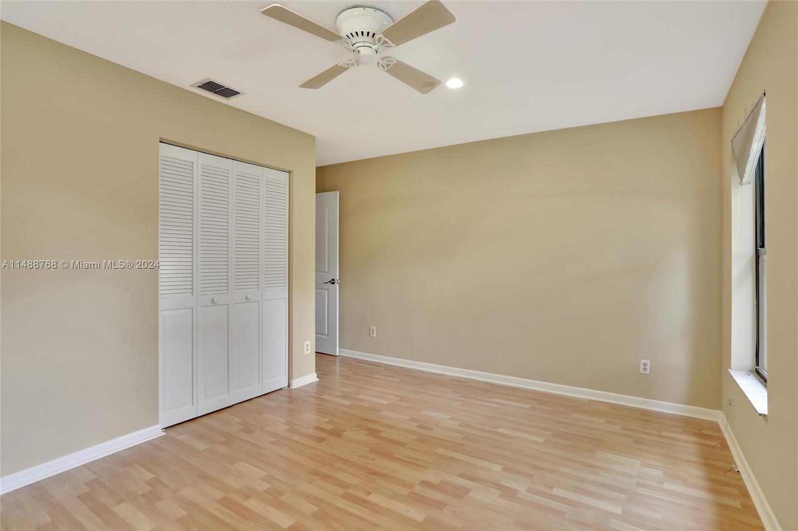 9641 Ridgeside Court Davie, FL 33328 - Photo 34 of 47 a view of an empty room with wooden floor and a ceiling fan