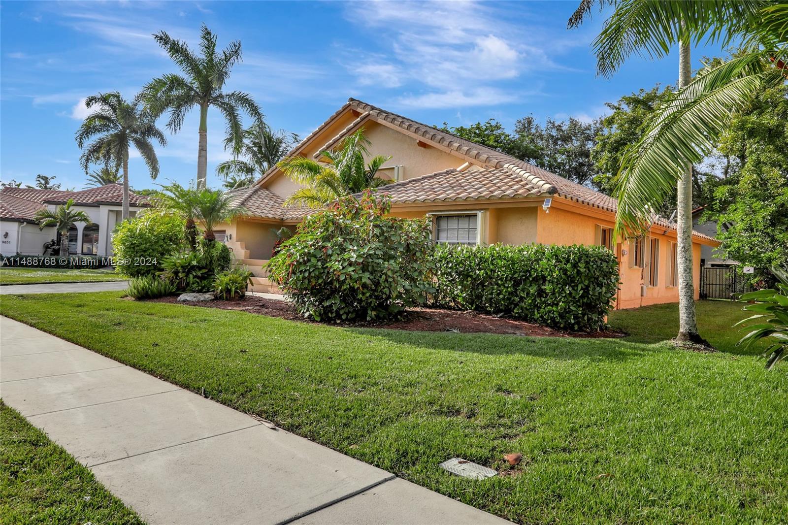 9641 Ridgeside Court Davie, FL 33328 - Photo 38 of 47 a view of a house with a yard and potted plants