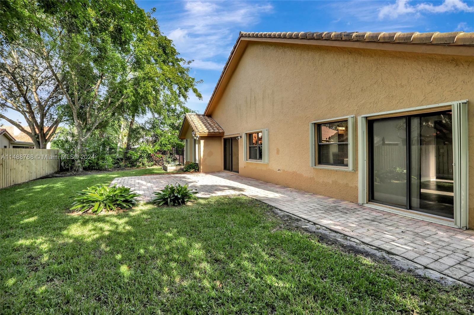 9641 Ridgeside Court Davie, FL 33328 - Photo 41 of 47 a backyard of a house with table and chairs