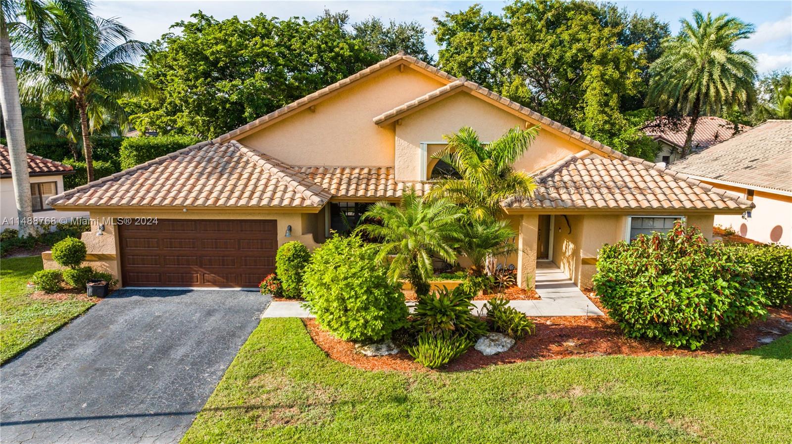 9641 Ridgeside Court Davie, FL 33328 - Photo 42 of 47 a front view of a house with a yard