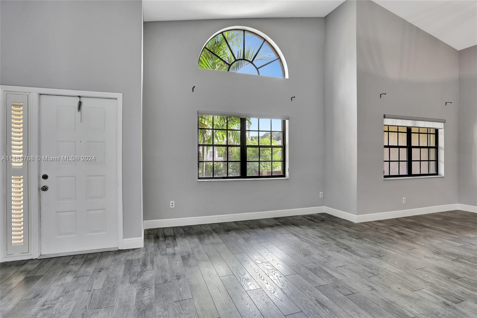 9641 Ridgeside Court Davie, FL 33328 - Photo 6 of 47 an empty room with windows and wooden floor