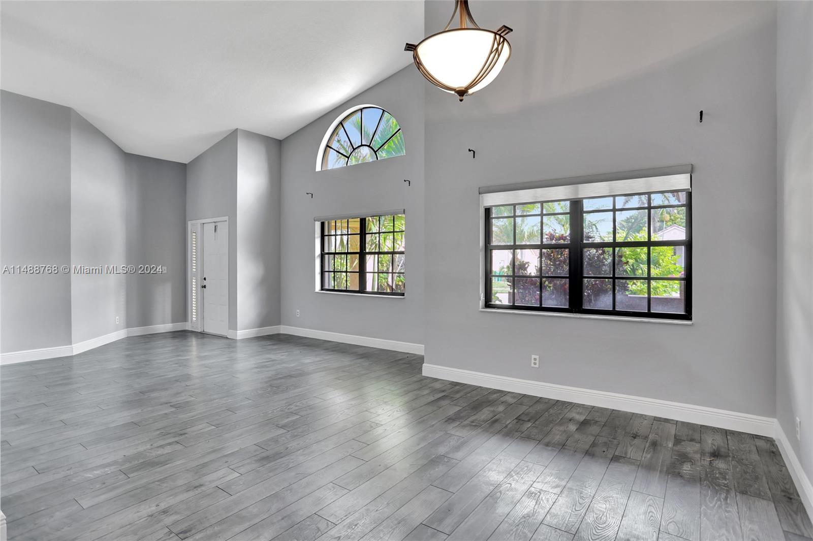 9641 Ridgeside Court Davie, FL 33328 - Photo 7 of 47 an empty room with wooden floor and windows