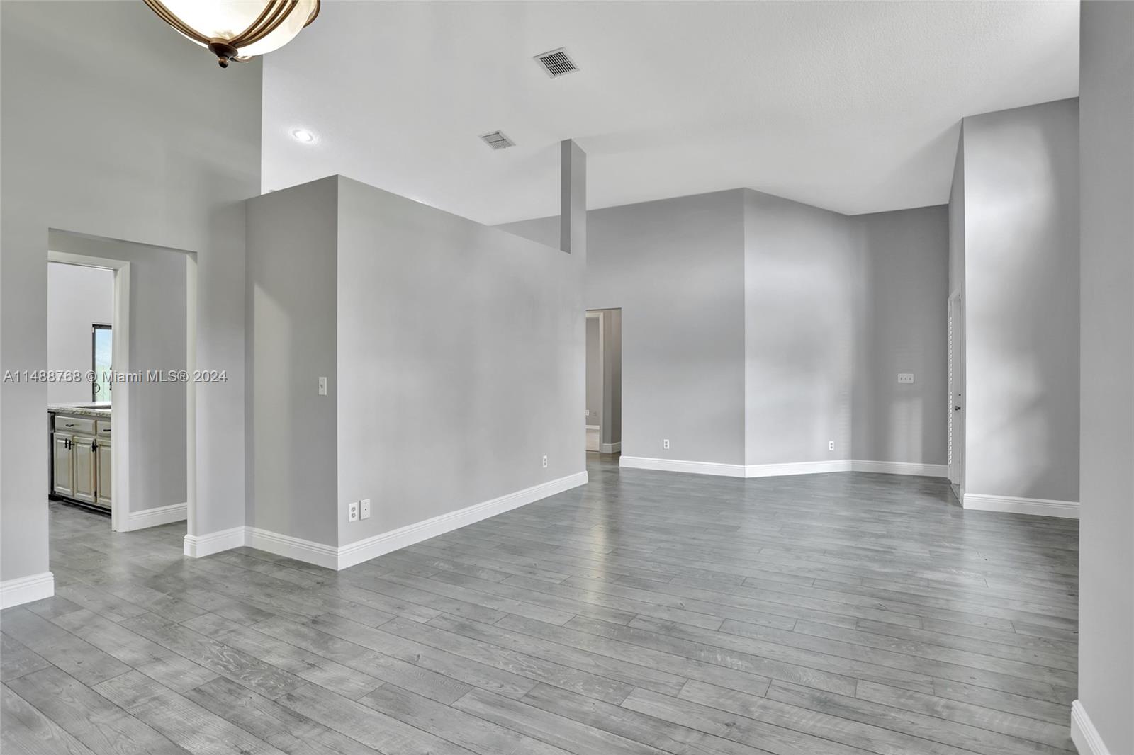 9641 Ridgeside Court Davie, FL 33328 - Photo 9 of 47 a view of an empty room with wooden floor