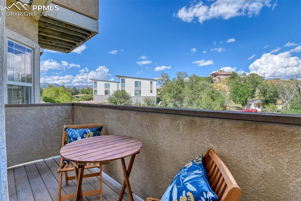 1431 Madison Ridge Heights, Unit C Colorado Springs, CO 80904 - Photo 12 of 44 a balcony with a table and chairs