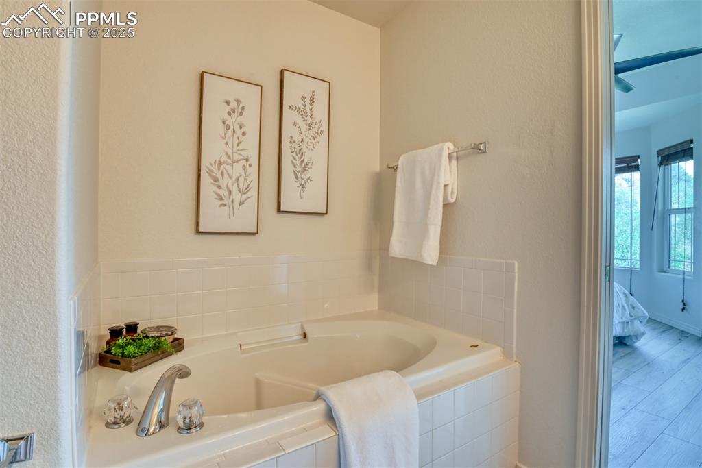 1431 Madison Ridge Heights, Unit C Colorado Springs, CO 80904 - Photo 21 of 44 a bath tub sitting next to a white sink