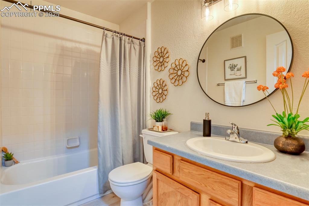 1431 Madison Ridge Heights, Unit C Colorado Springs, CO 80904 - Photo 26 of 44 a bathroom with a sink and a mirror