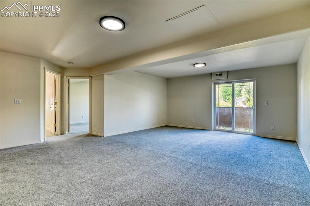 1431 Madison Ridge Heights, Unit C Colorado Springs, CO 80904 - Photo 31 of 44 an empty room with windows and closet