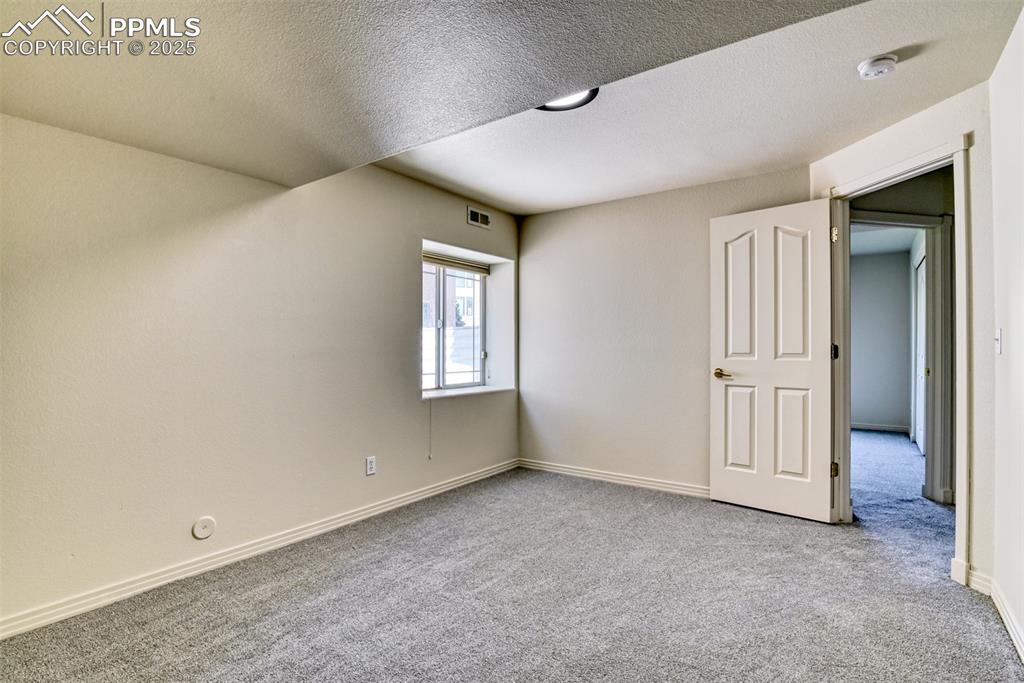 1431 Madison Ridge Heights, Unit C Colorado Springs, CO 80904 - Photo 41 of 44 an empty room with windows