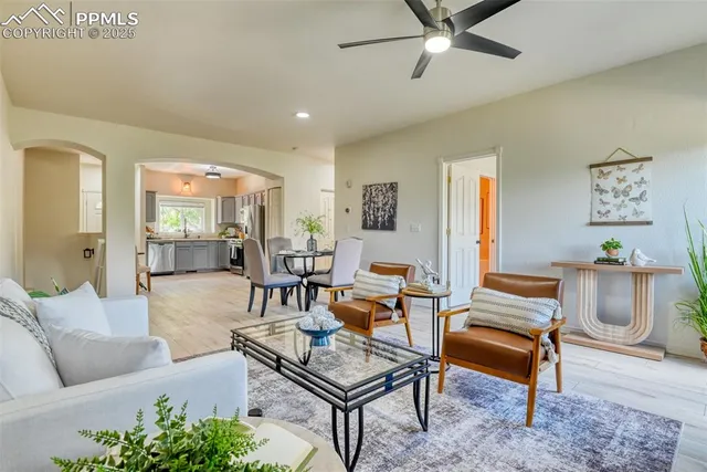 a living room with furniture and wooden floor