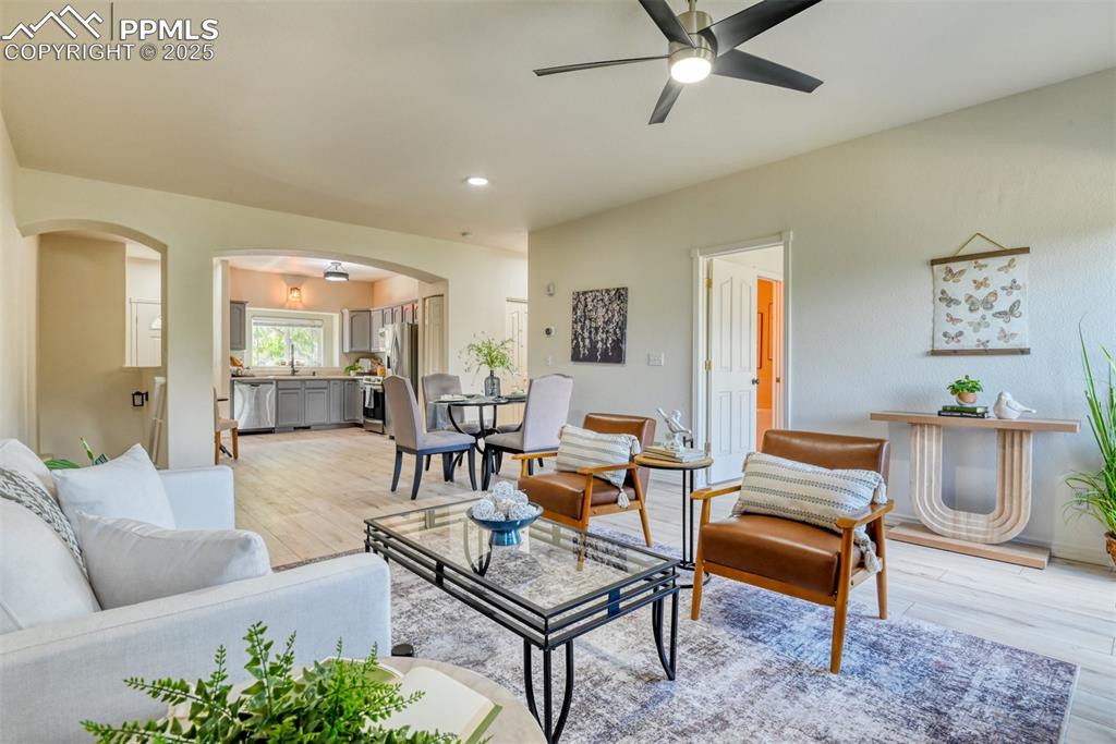 1431 Madison Ridge Heights, Unit C Colorado Springs, CO 80904 - Photo 7 of 44 a living room with furniture and wooden floor