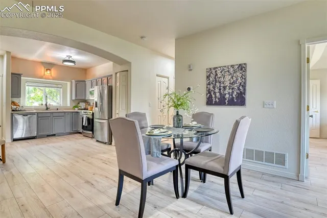 a view of a dining room with furniture and wooden floor
