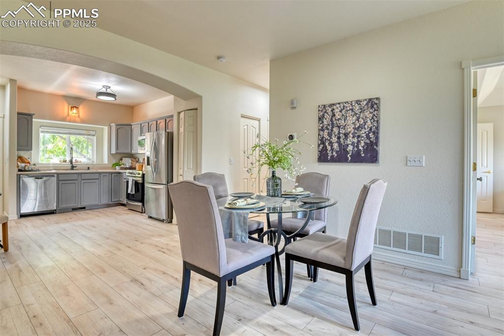 1431 Madison Ridge Heights, Unit C Colorado Springs, CO 80904 - Photo 9 of 44 a view of a dining room with furniture and wooden floor