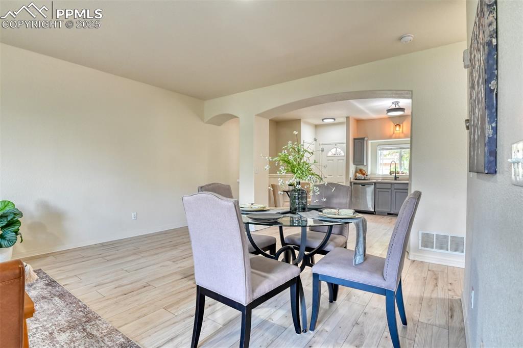 1431 Madison Ridge Heights, Unit C Colorado Springs, CO 80904 - Photo 10 of 44 a view of a dining room with furniture and wooden floor