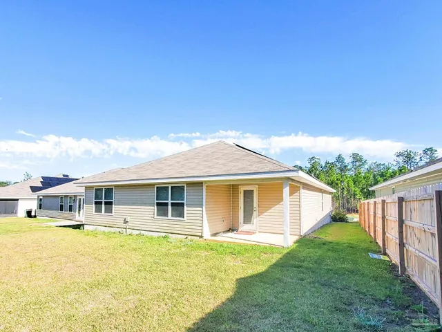 a view of a house with a backyard