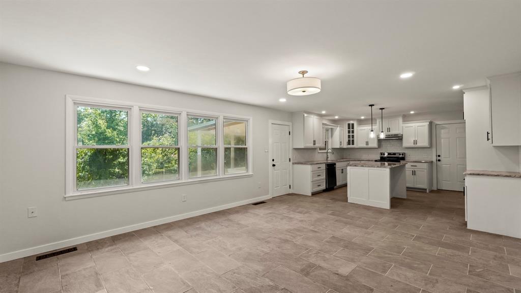 4600 Robinwood Drive Waco, TX 76708 - Photo 6 of 24 a open kitchen with white cabinets and white appliances