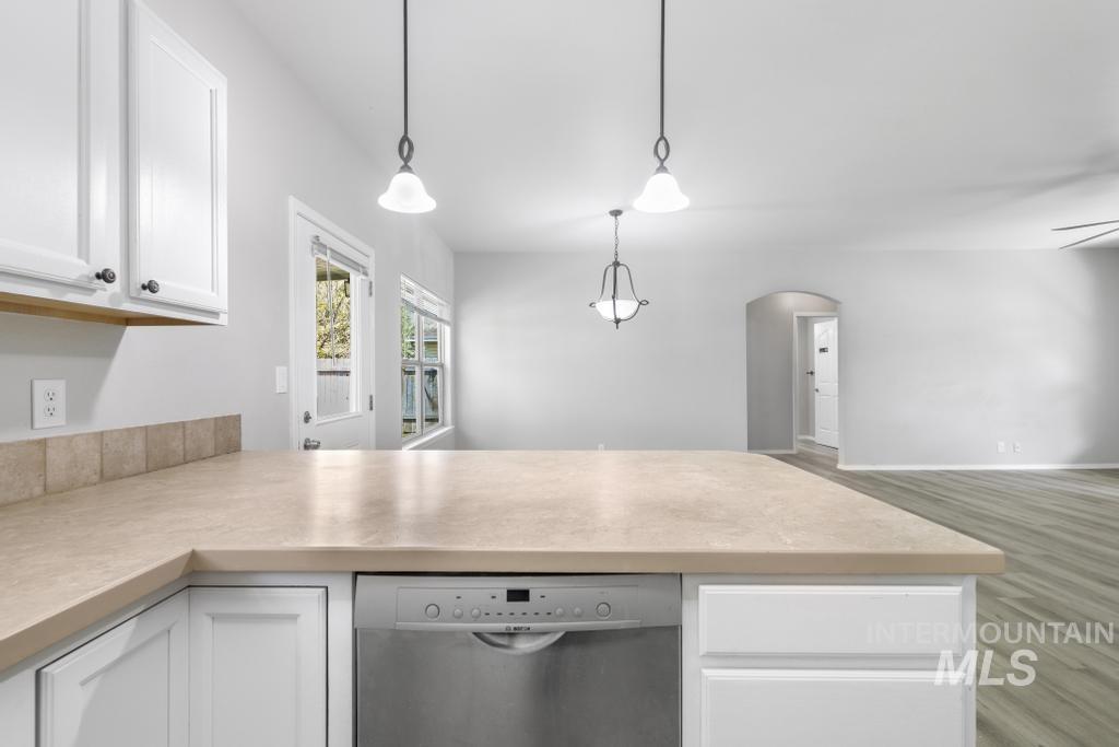 1183 Cortes Loop Twin Falls, ID 83301 - Photo 7 of 30 Kitchen island with neutral countertop and integrated stainless steel dishwasher