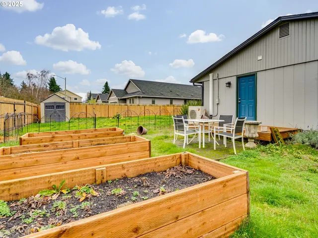 a view of a backyard with chairs and a patio