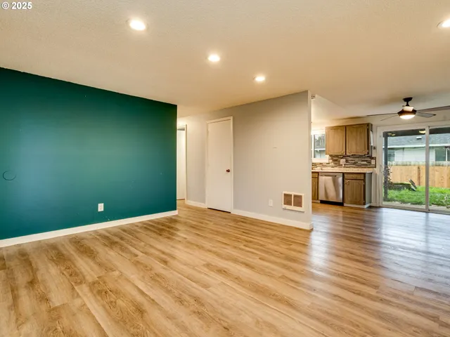 a view of empty room with a fireplace and window