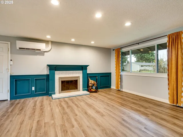 a view of a livingroom with a fireplace and a workspace