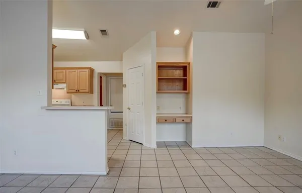 a kitchen with a sink a refrigerator and cabinets