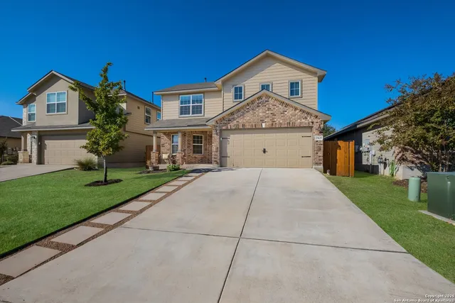 a living room with furniture and a ceiling fan
