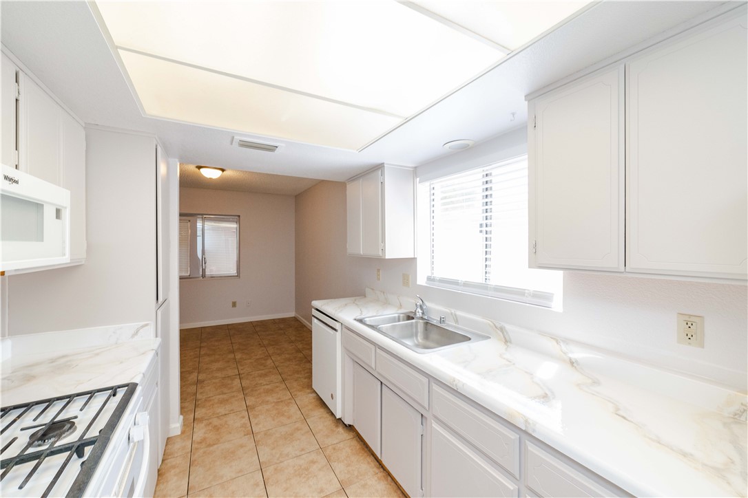 980 Canyon Hills Road Kingman, AZ 86409 - Photo 15 of 42 a kitchen with a sink stove and cabinets