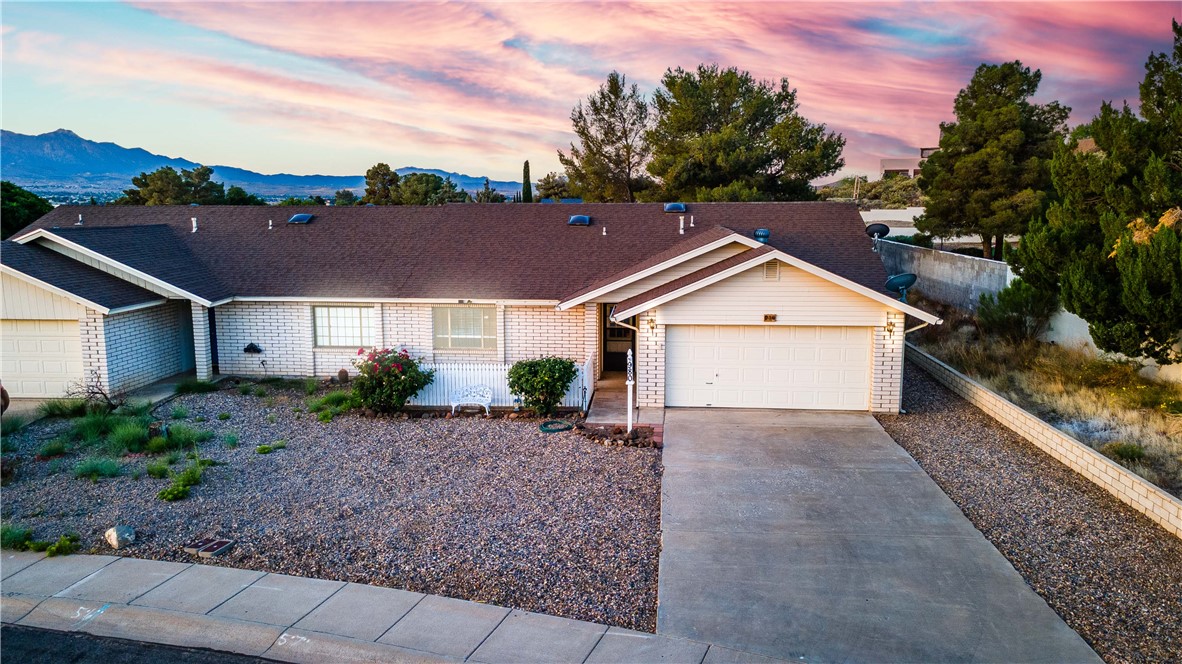 980 Canyon Hills Road Kingman, AZ 86409 - Photo 2 of 42 a front view of a house with a yard and garage