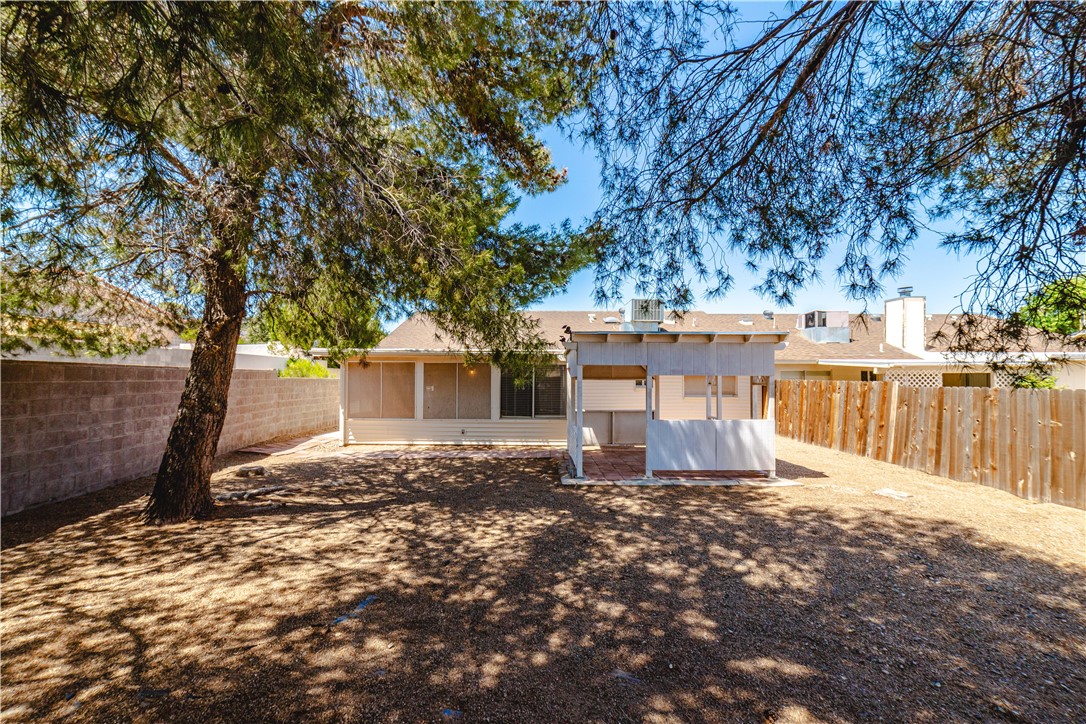 980 Canyon Hills Road Kingman, AZ 86409 - Photo 37 of 42 a view of a house with large tree and wooden fence